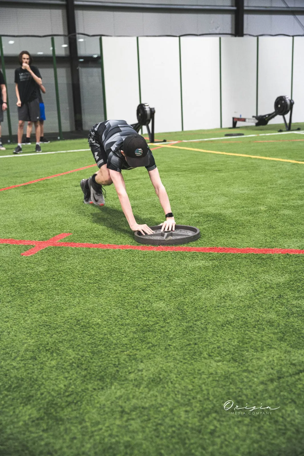 An athlete in an agility drill on the turf