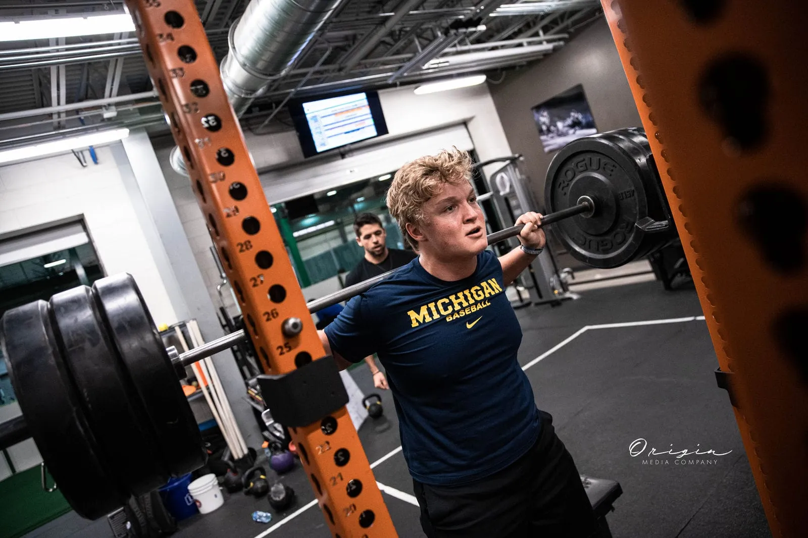 An athlete performing a barbell squat