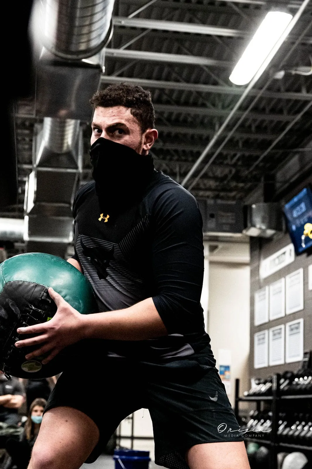 A boxer training explosively with a medicine ball at Impact