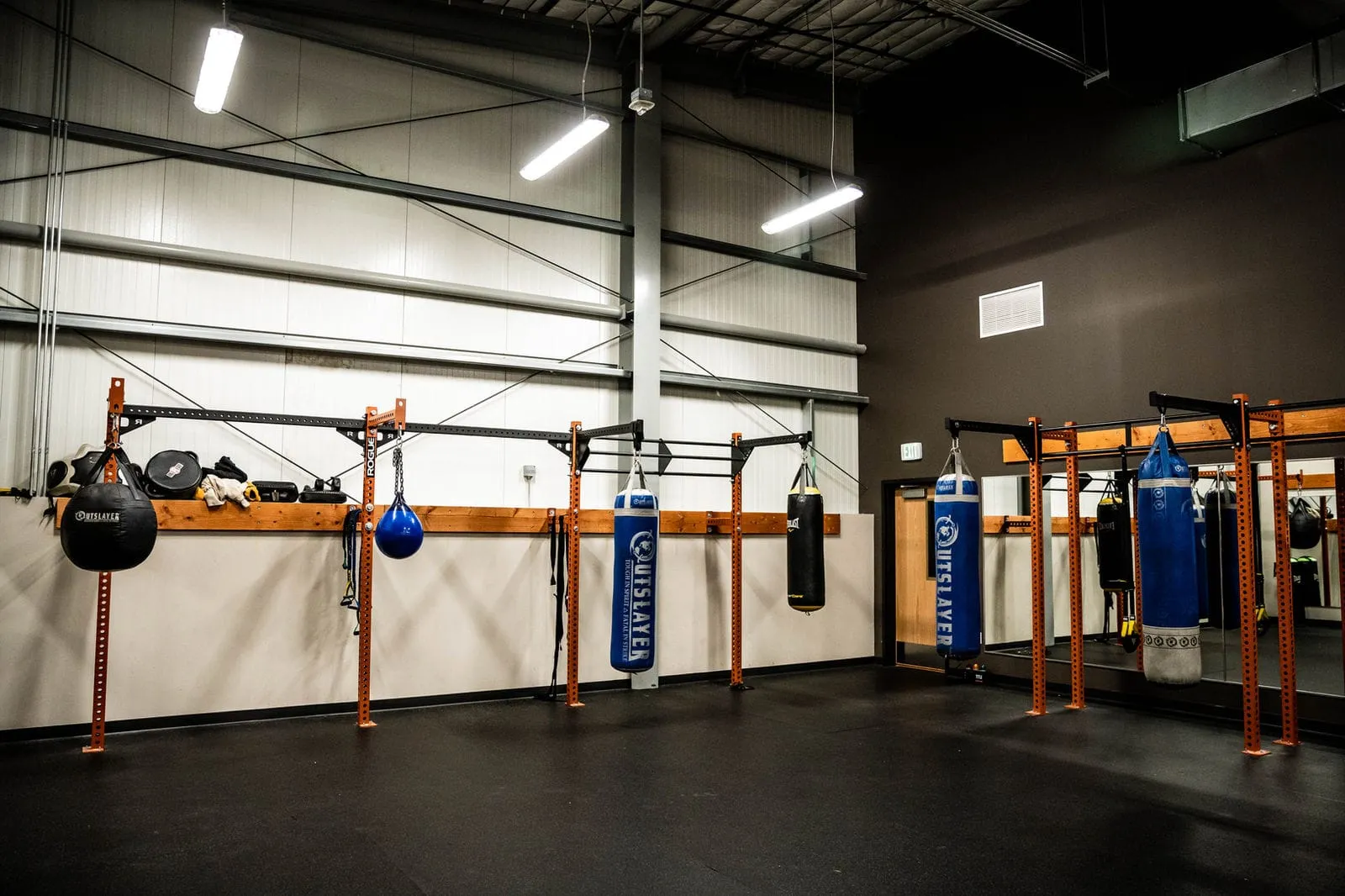 A row of heavy bags in the boxing studio
