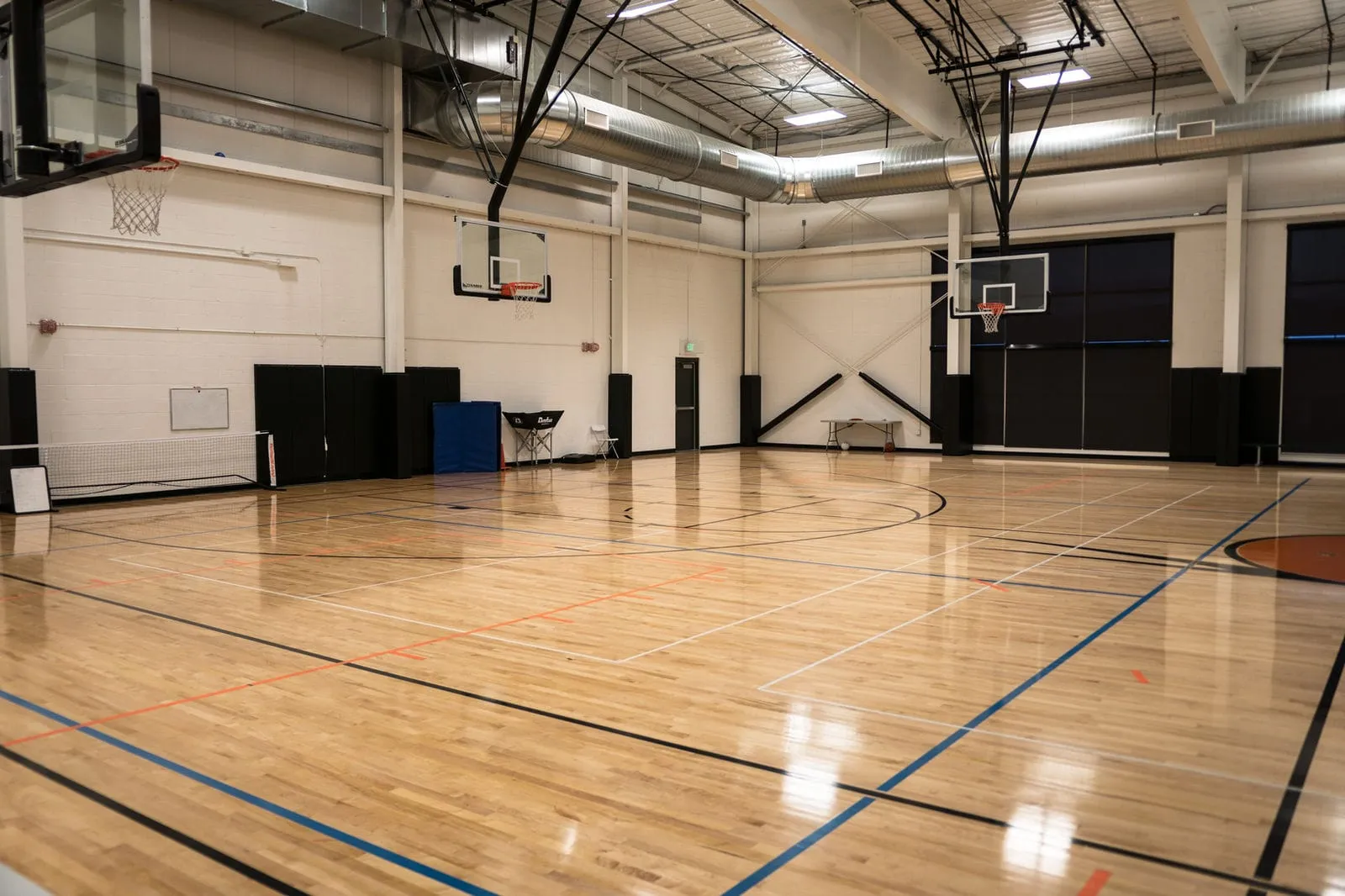 Multi-use basketball and volleyball court