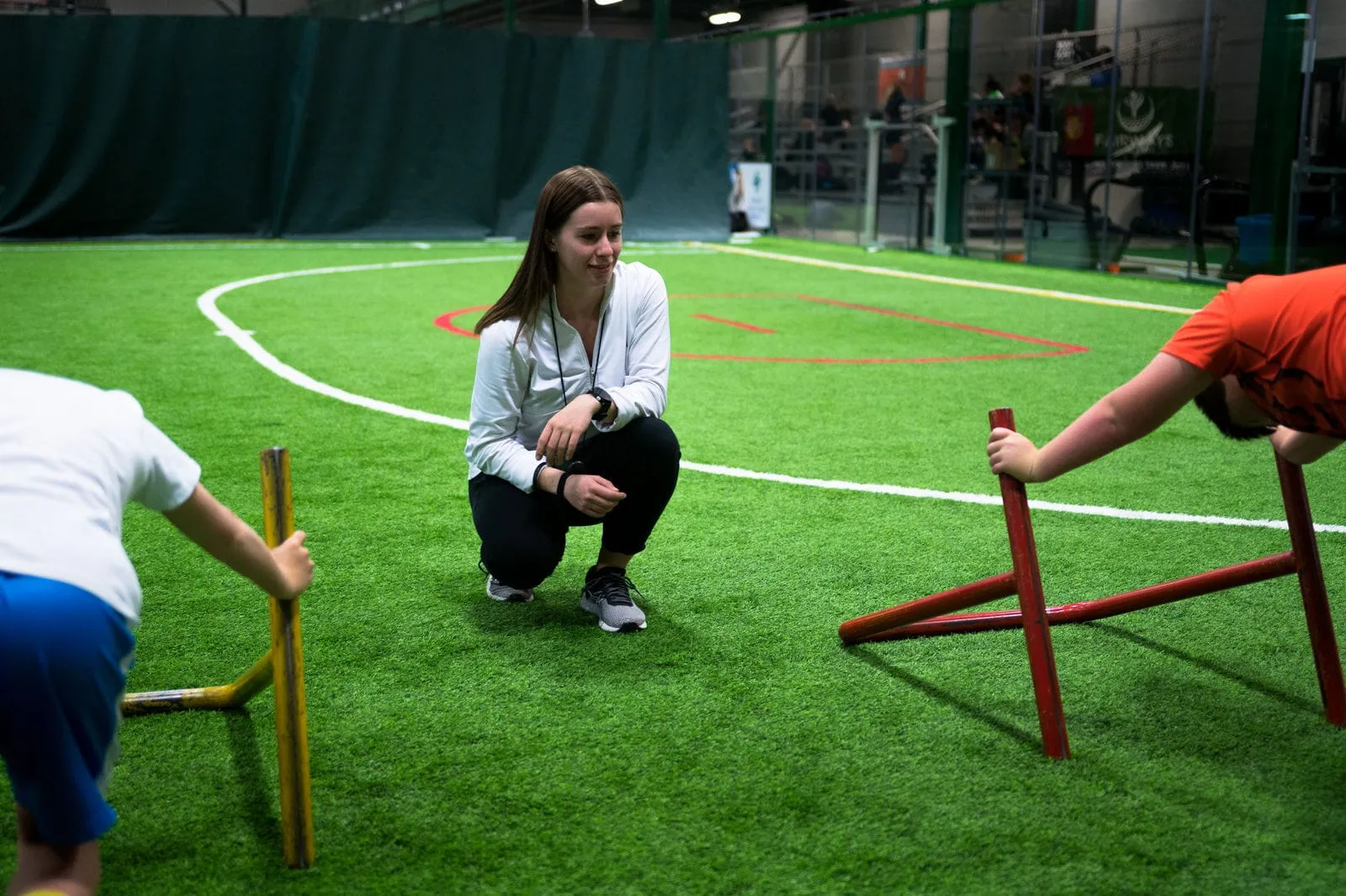 A coach leading a kids agility drill