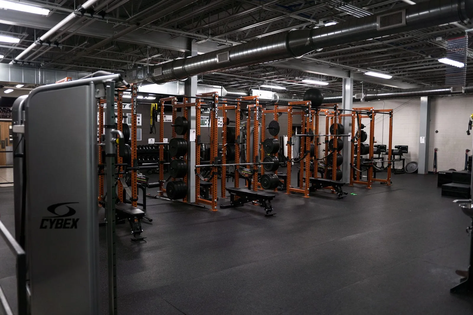 Team training room with squat racks and cable machines