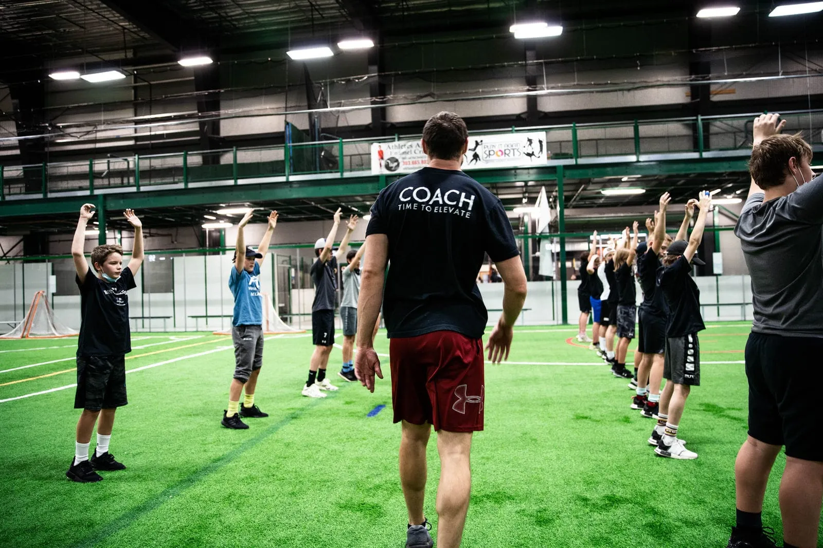 A team workout on the turf with coaches